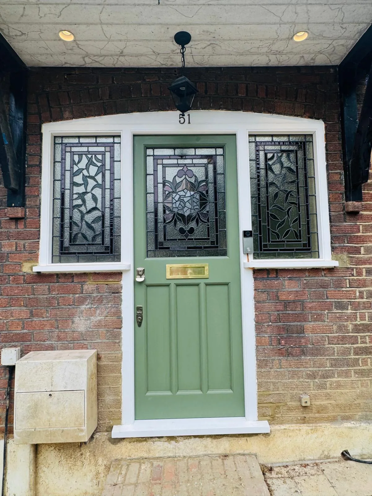 Bespoke Accoya timber entrance door in soft sage-green with matching stained glass side windows, North London
