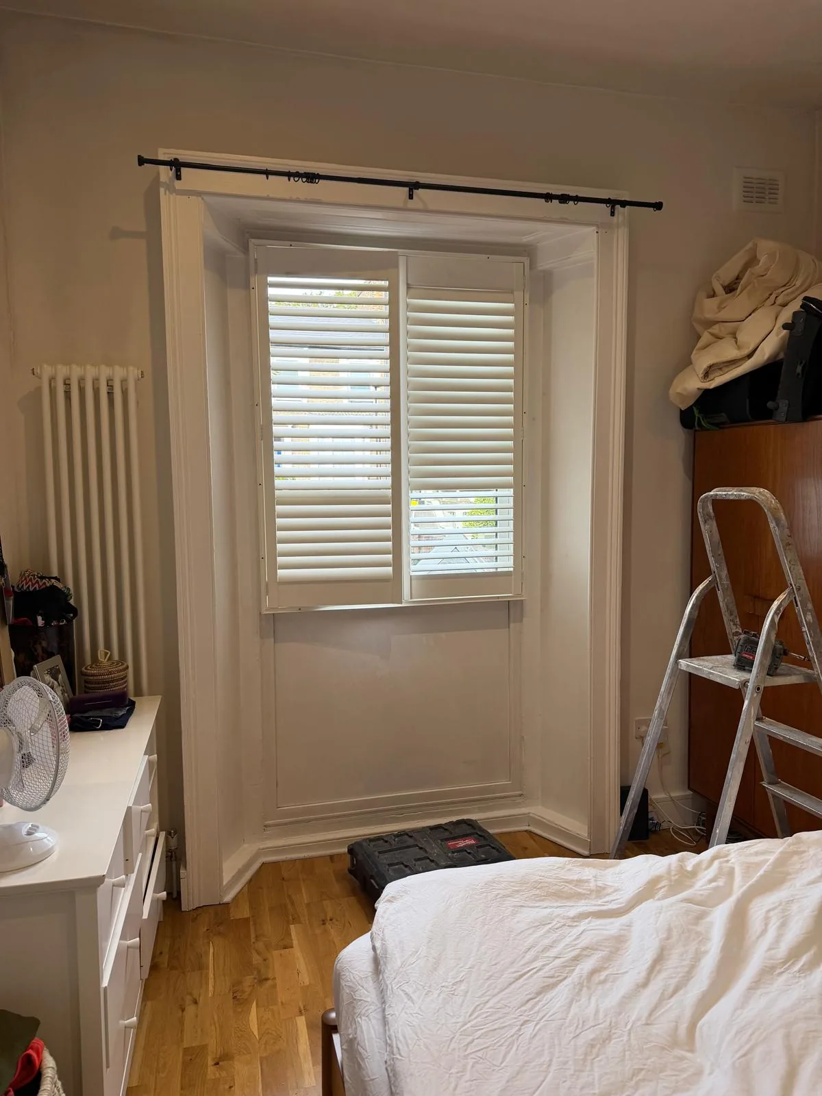 The bedroom before, with the old PVC window and shutters