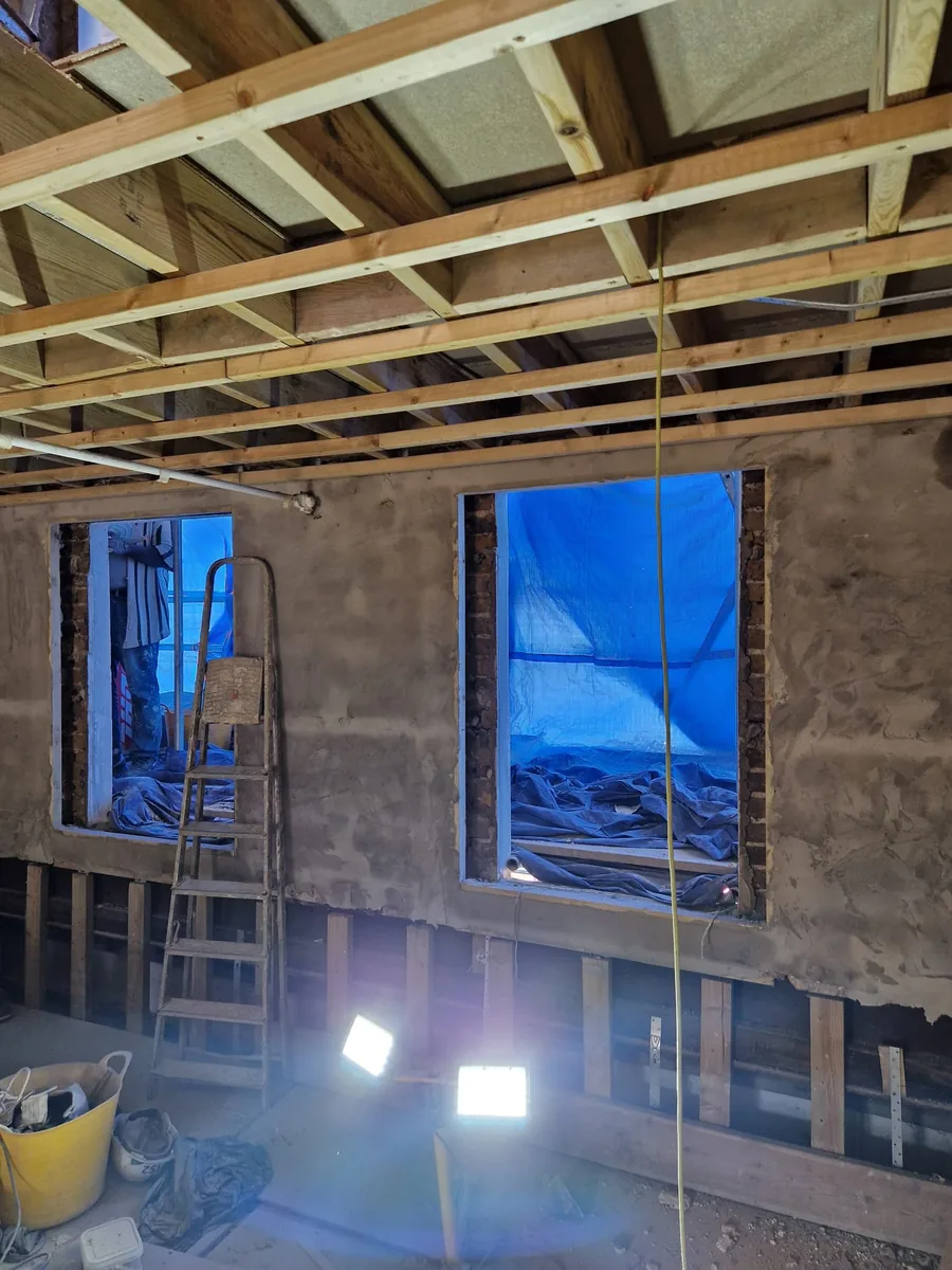 Building stripped back to bare brick and joists in Hackney before the heritage glass sash windows were fitted