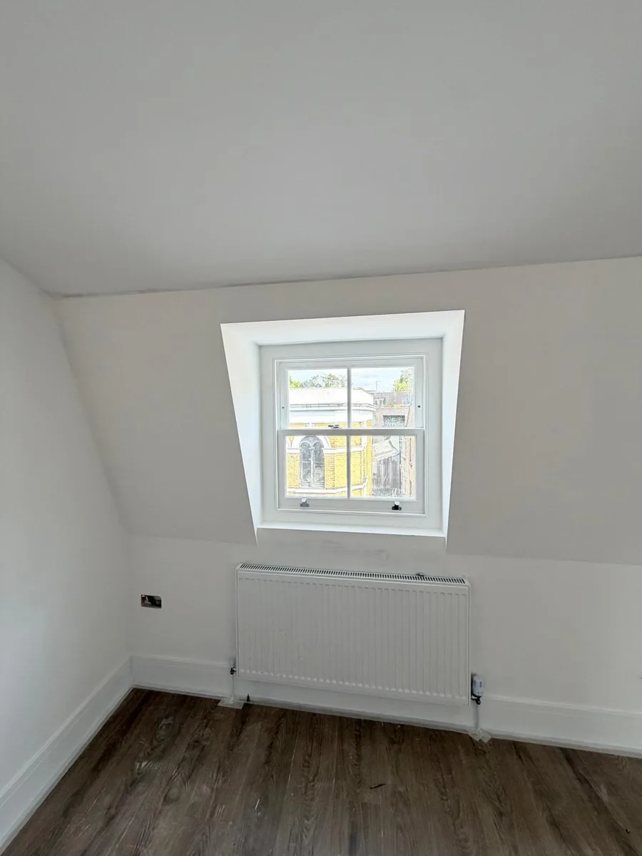 Completed loft room with a heritage glass dormer sash window, Hackney
