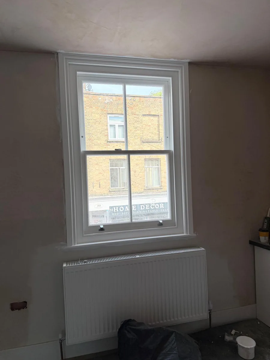 Heritage glass sash window fitted into a freshly plastered room in Hackney