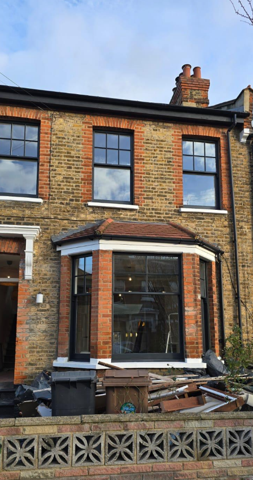 Restored timber sash windows on a Victorian terraced house in Stoke Newington London