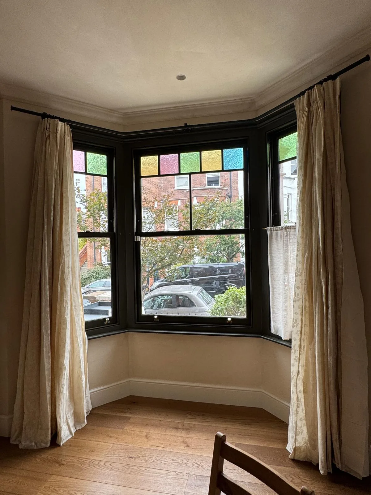 Interior view of the Islington bay showing the retained Victorian stained glass margin lights and slim sightlines of the heritage double glazing