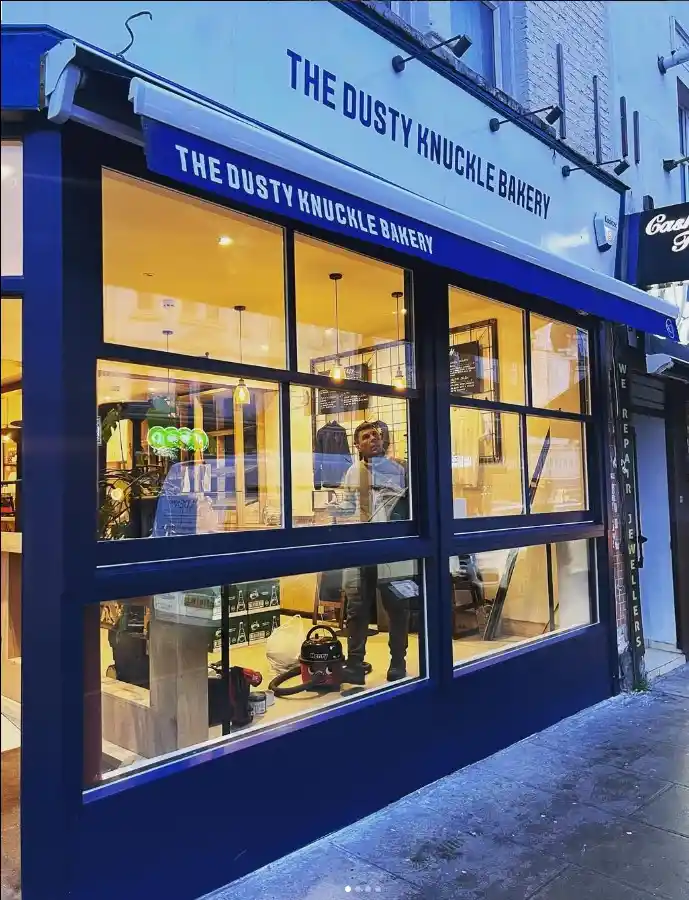 The Dusty Knuckle Bakery storefront in London featuring bespoke blue timber window frames