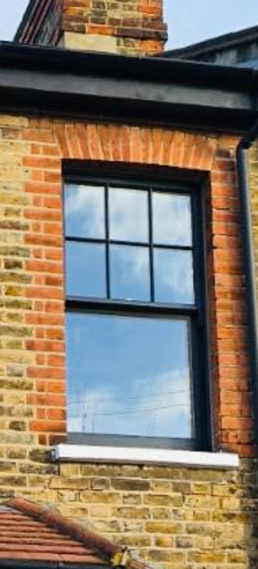 Restored timber sash window with traditional glazing bars in a Victorian property in Stoke Newington