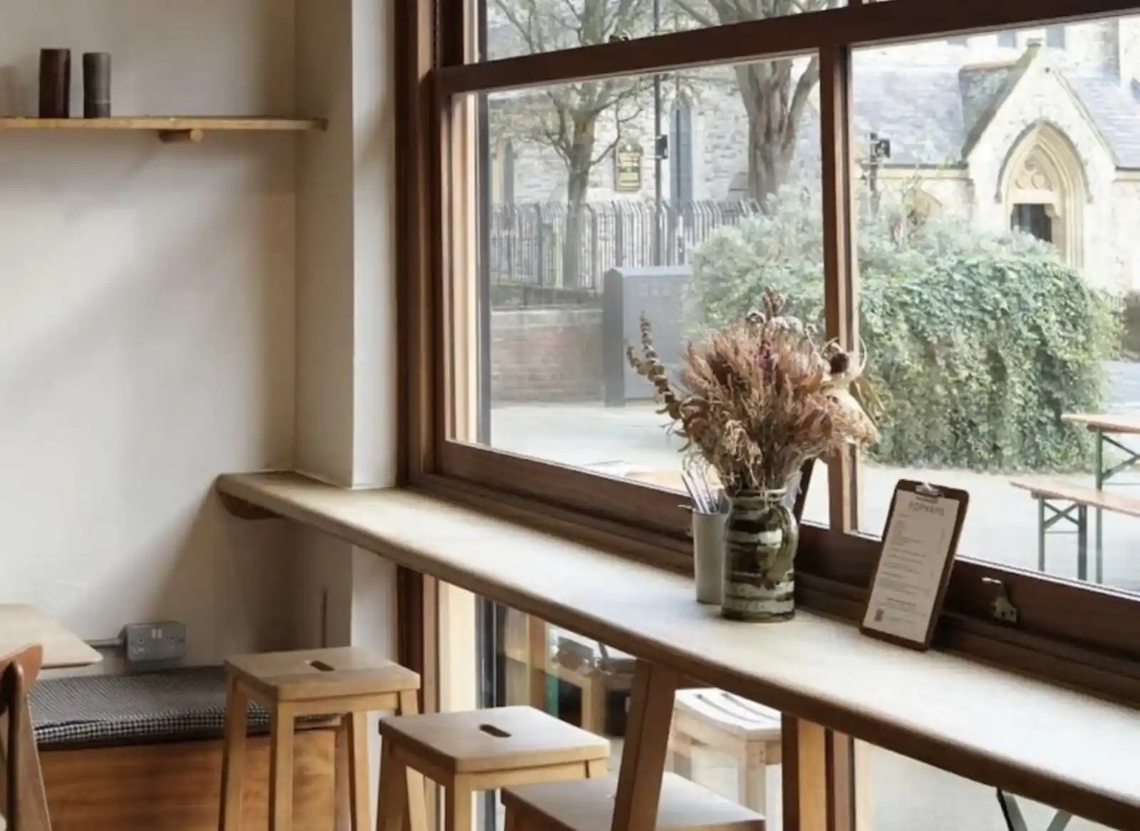 The view from inside a newly installed commercial storefront showing clean timber frame lines and natural light